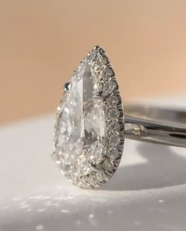 3 ct Pear cut Moissanite with halo and plain band