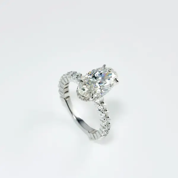 5.3ct Crushed ice Oval Moissanite with hidden halo and half eternity round Moissanite pavé Band - Image 5
