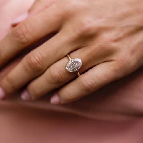 4Ct Crushed Ice Oval Moissanite in a Bezel Setting