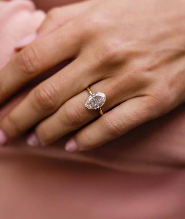 4Ct Crushed Ice Oval Moissanite in a Bezel Setting