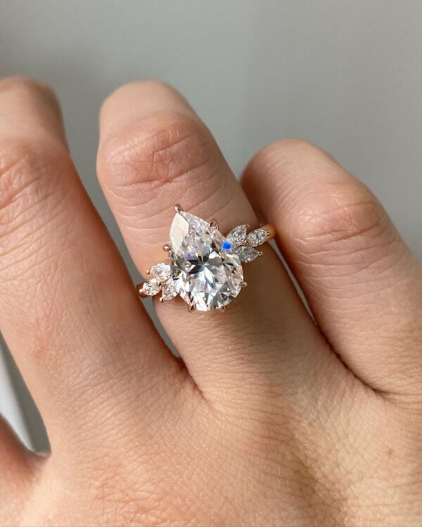 4ct Pear Moissanite with Marquise Cluster Side Stones