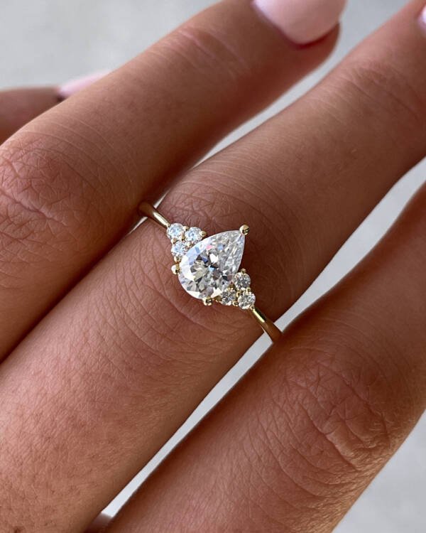 1ct Pear Moissanite with Cluster Stones